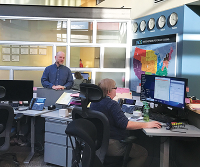 Roger Brown (left) is the director of the Organ Center at UNOS. This mission control-style command center is the heart of the organization.