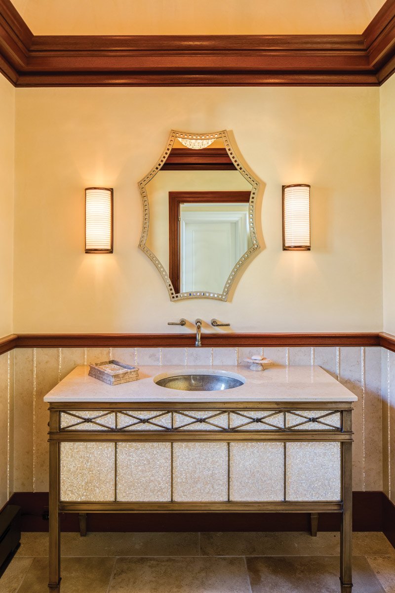 Custom designed bronze and Mother of Pearl vanity in the powder room.