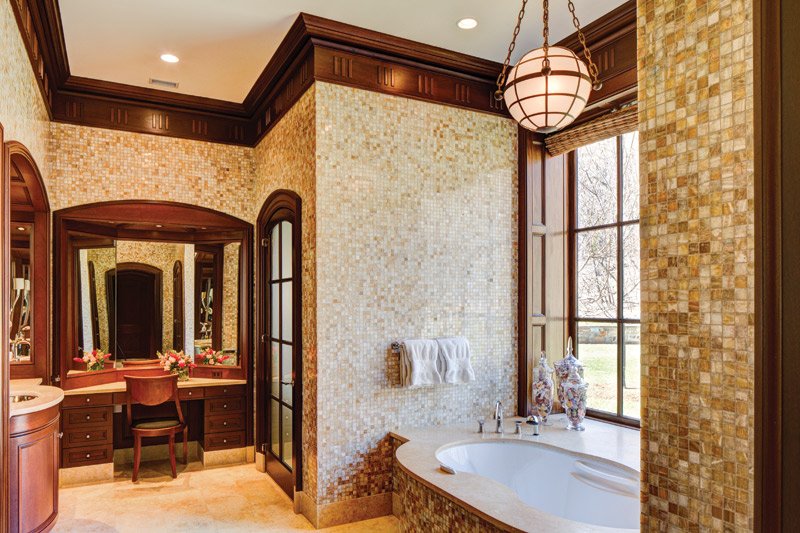 Onyx tiles in the master bathroom complement mahogany windows and doors used throughout the house.